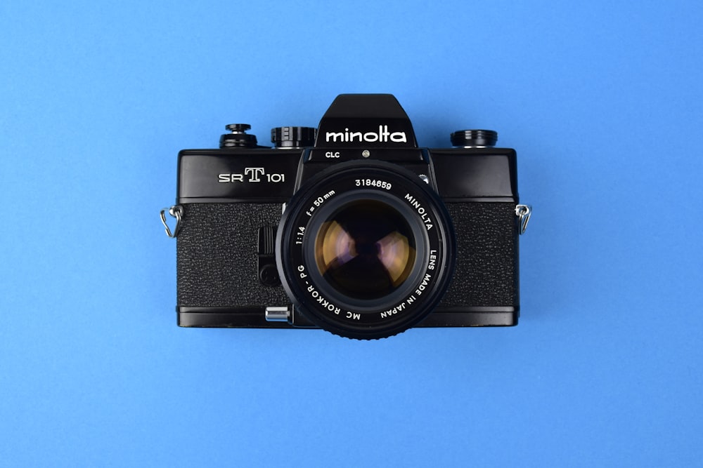 a camera on a blue background with a black lens