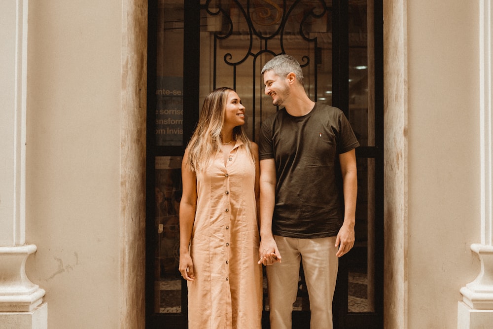 a man and a woman standing in front of a door