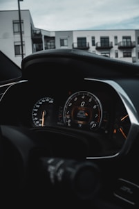 A sleek digital dashboard showing real-time traffic fine alerts against a backdrop of the Swiss Alps.