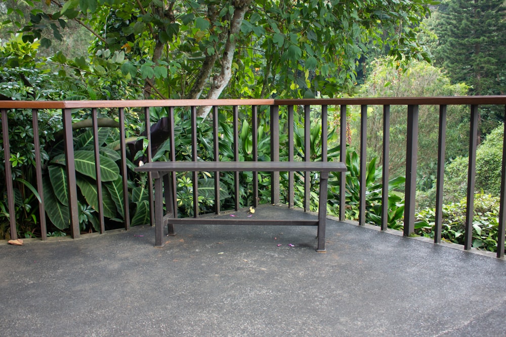 a wooden bench sitting on top of a metal rail