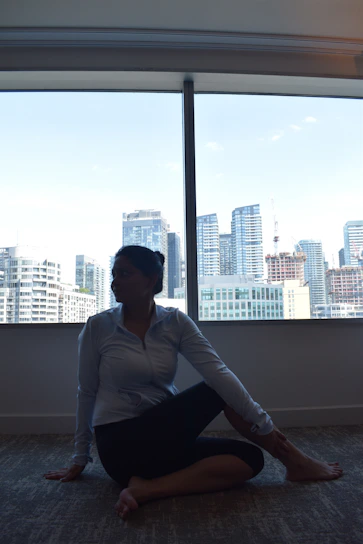 A serene morning scene with a person practicing gentle yoga by a sunny window.