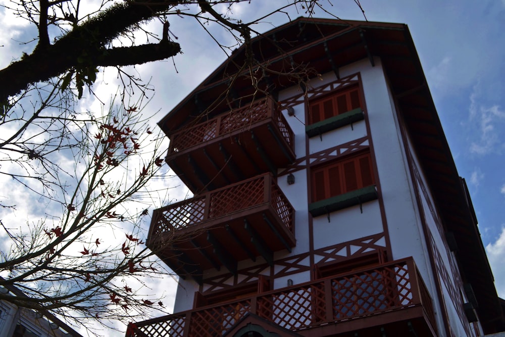 a red and white building with red balconies