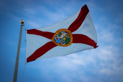 the flag of the state of florida flies high in the sky