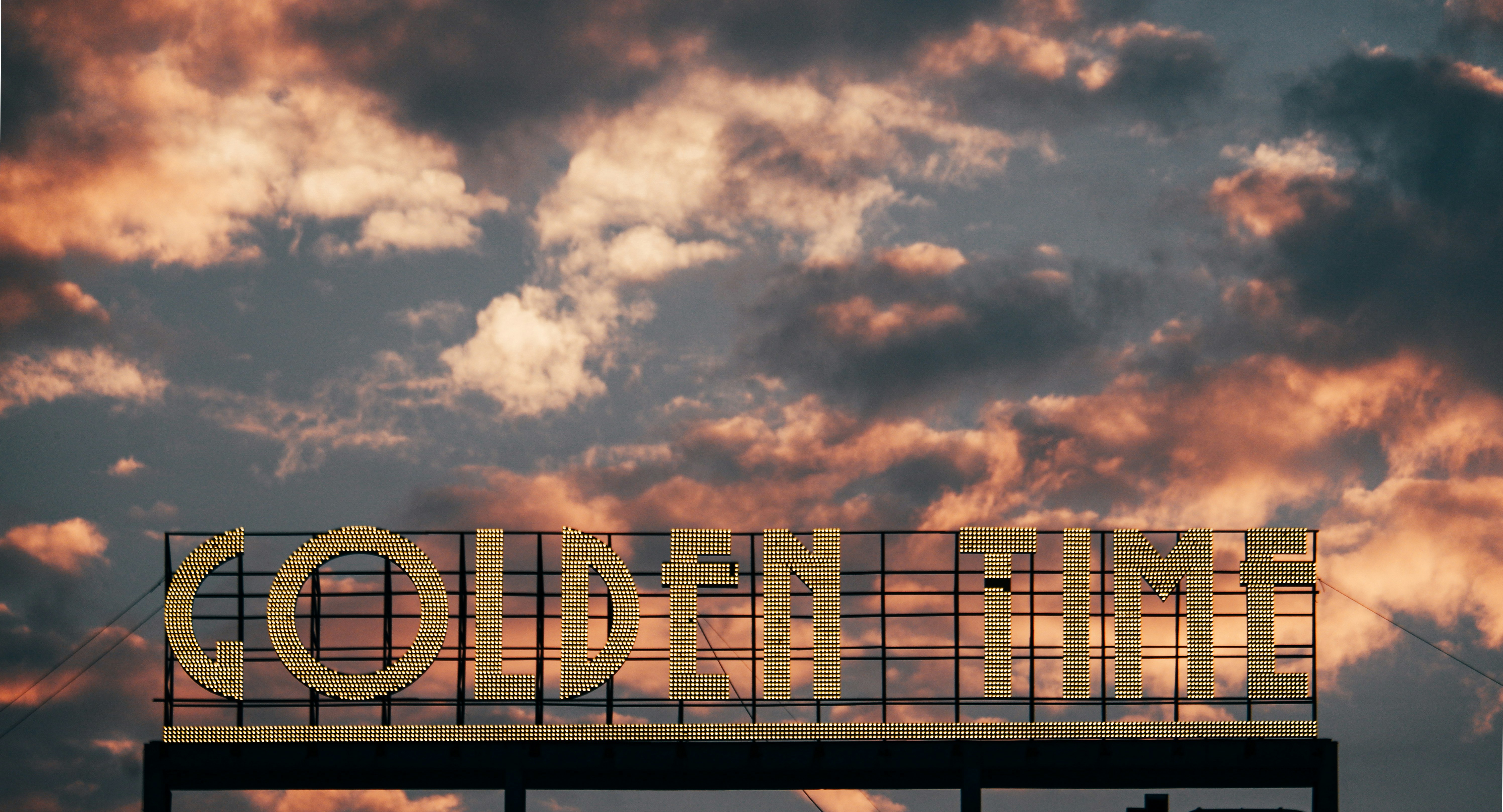 a sign that reads conn - time on a cloudy day