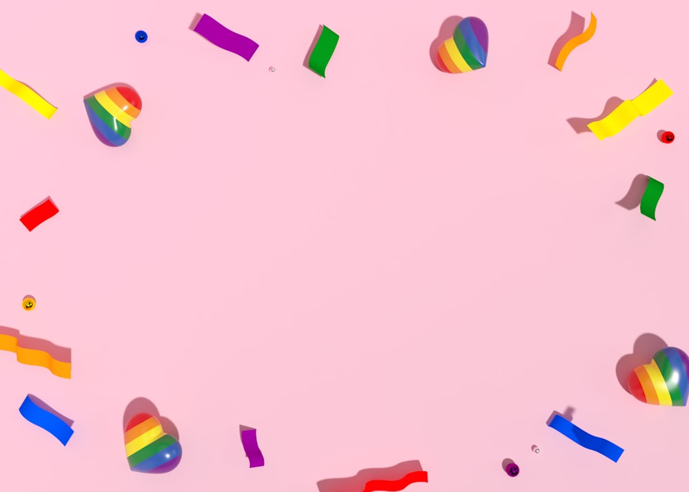 colorful streamers and confetti on a pink background