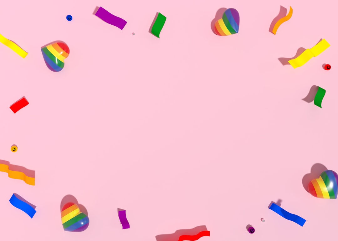 colorful streamers and confetti on a pink background,