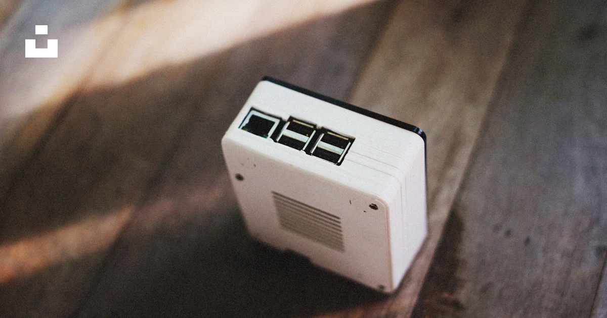 A small white computer sitting on top of a wooden floor photo – Free ...