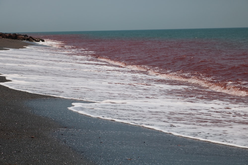 a beach with waves coming in to shore