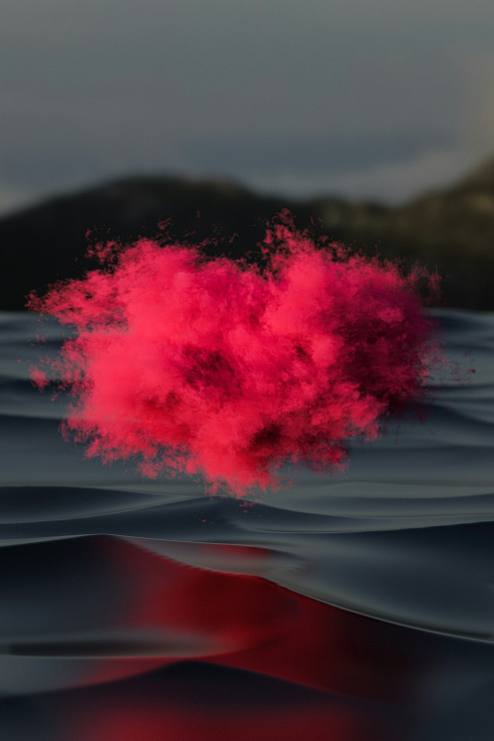 a pink substance is floating in the water