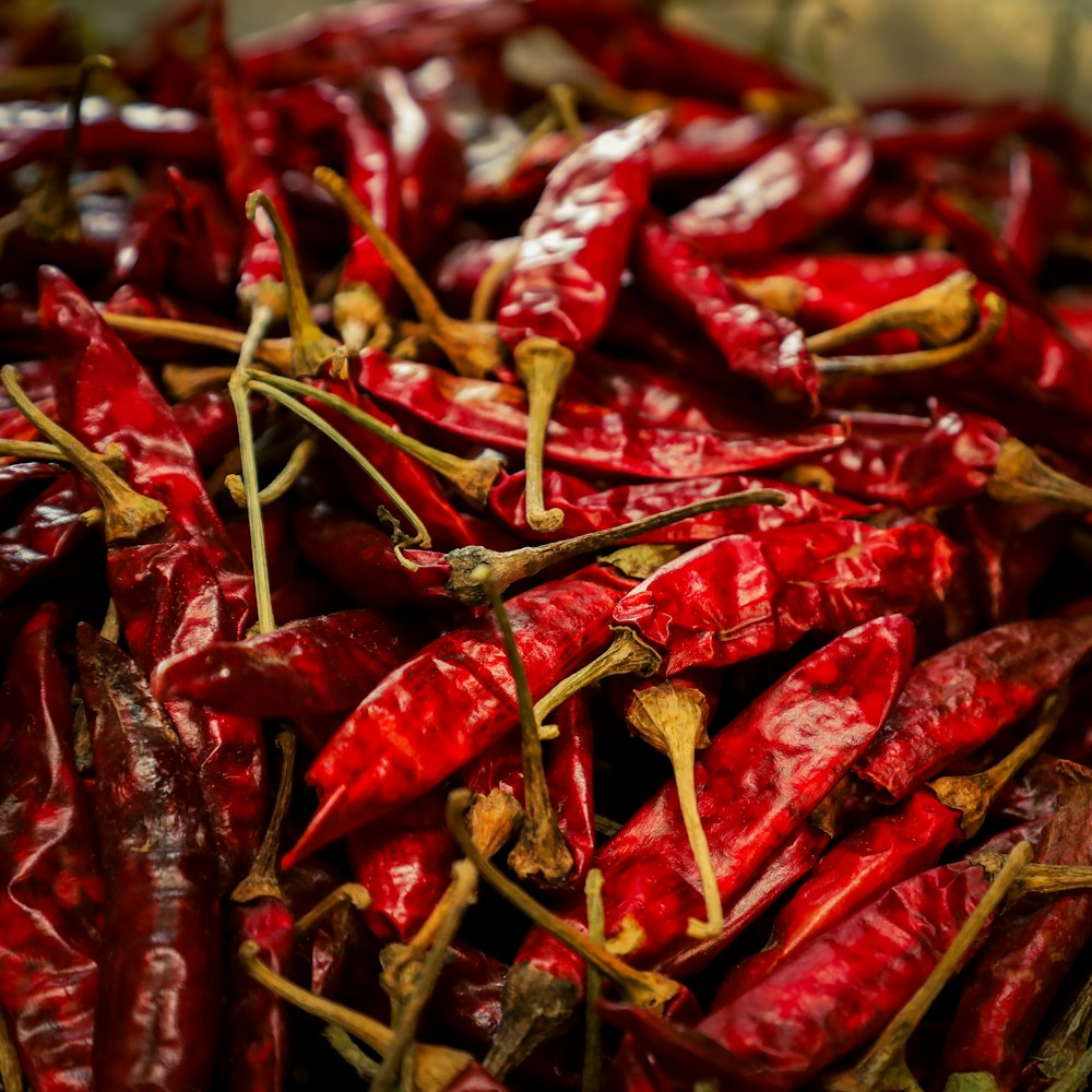 a pile of red peppers sitting on top of a table