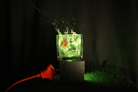 Mad scientist dunking a green powder packet into a beaker amid a yellow lightning explosion.