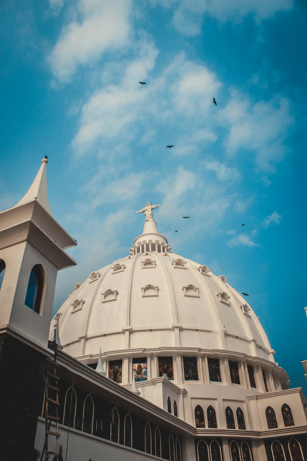 a large white dome with a cross on top of it