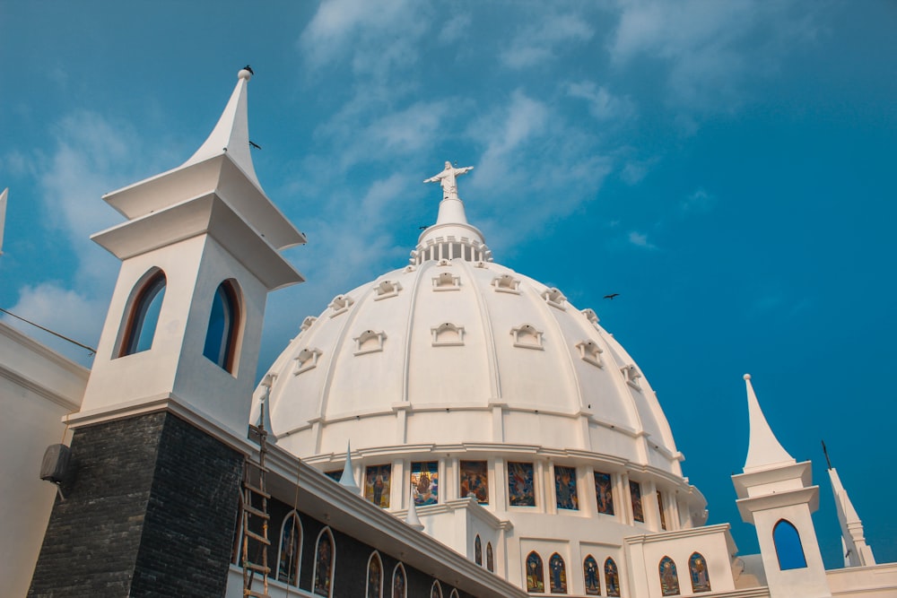 a large white building with a cross on top