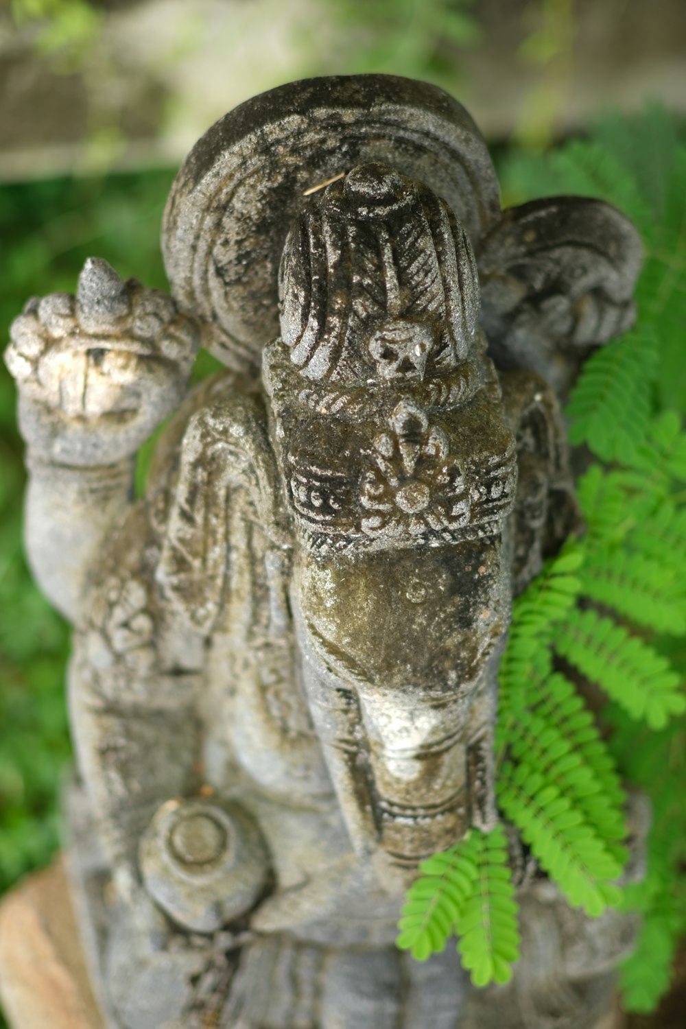 a statue of an elephant and a fern