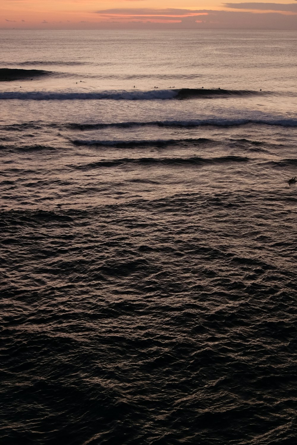 a person riding a surf board on a body of water