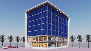 a large blue building with palm trees in front of it