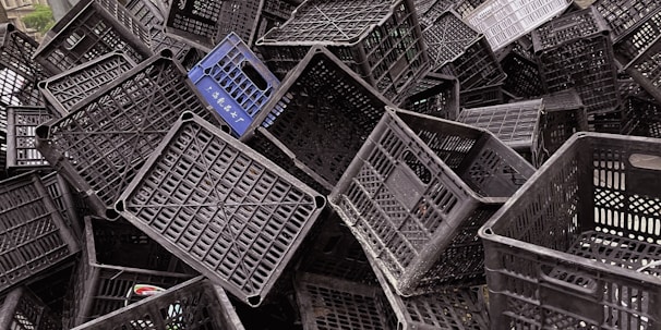 Close-up of interlocking plastic crates highlighting their secure stacking feature.