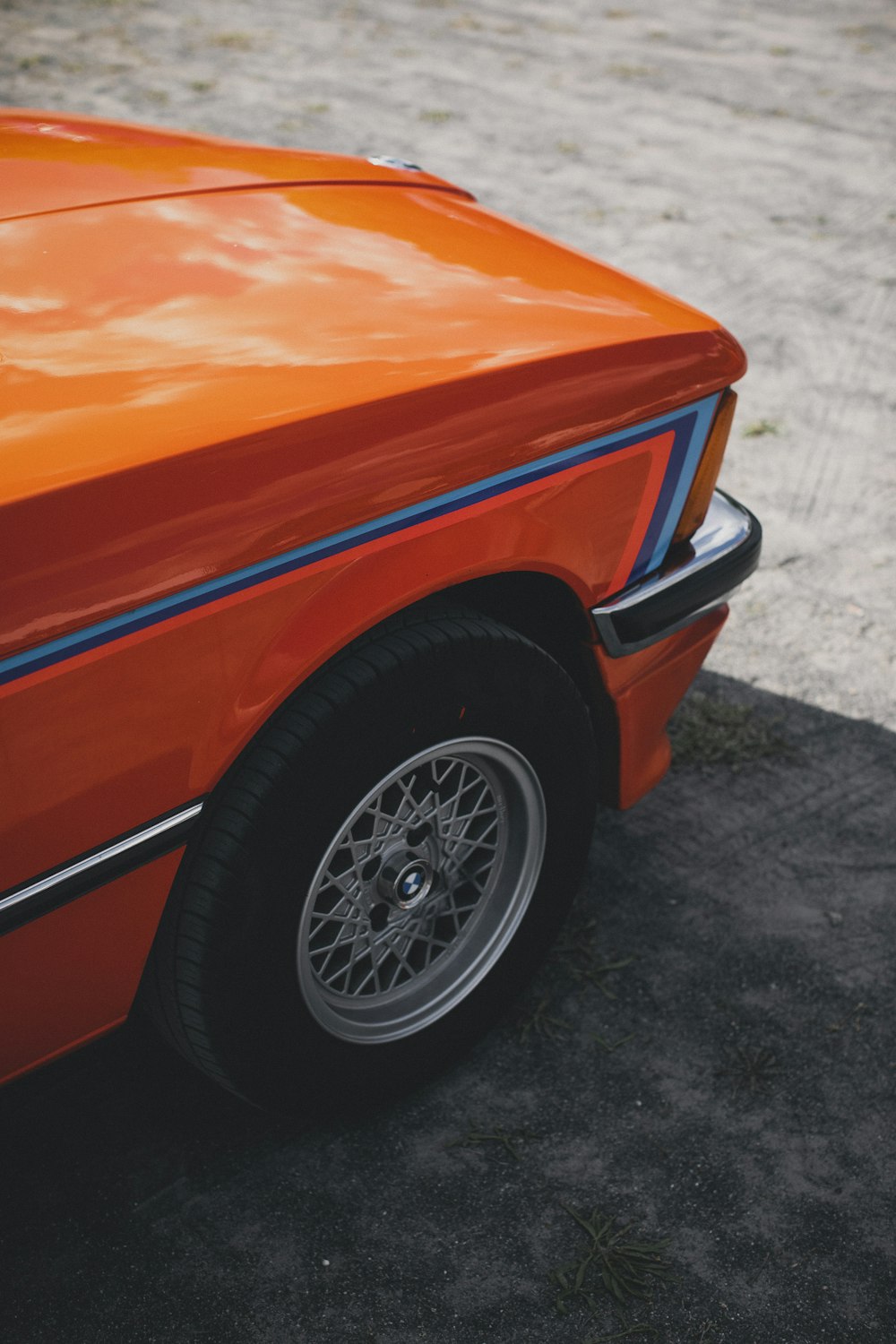 an orange car parked in a parking lot