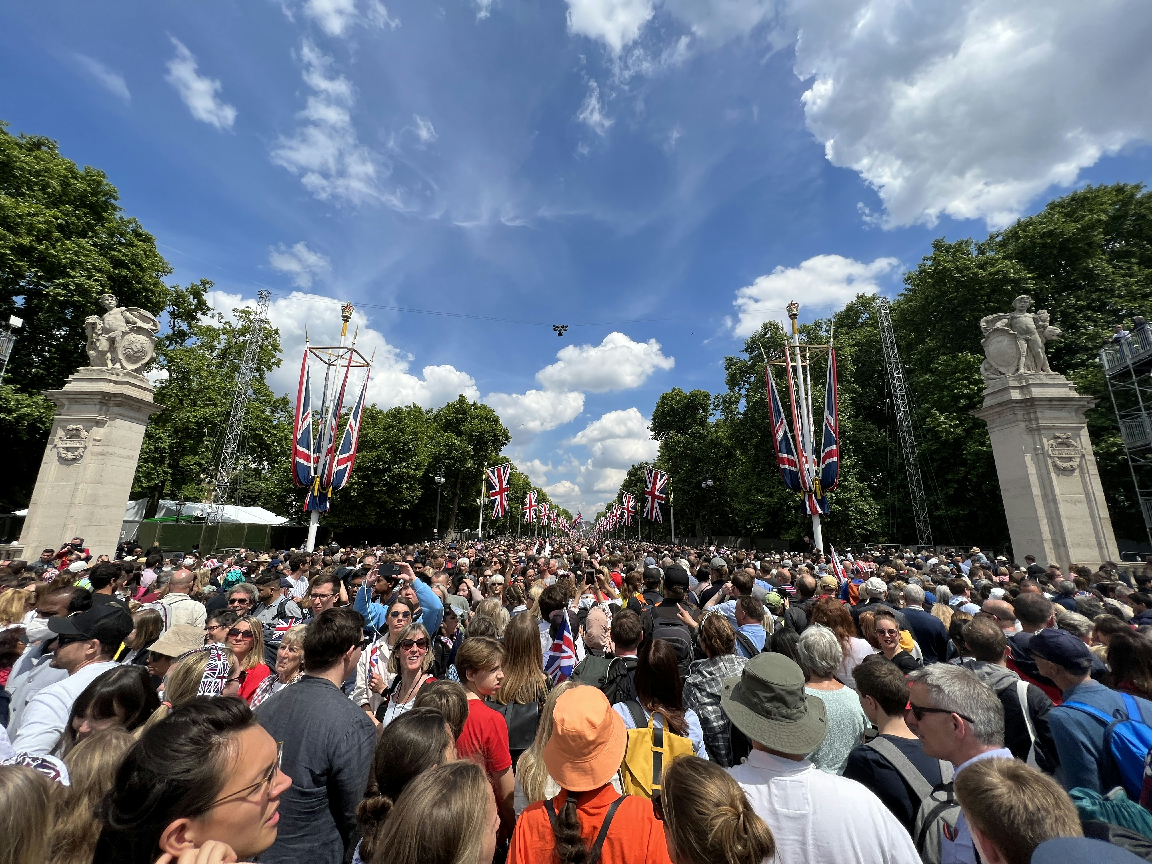 a large crowd of people standing in a park
