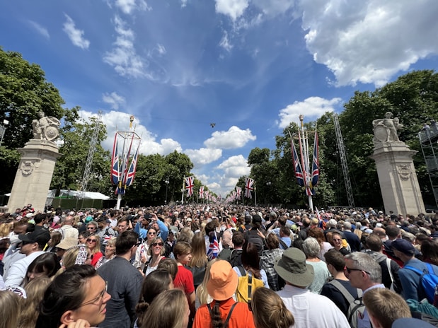 a large crowd of people standing in a park