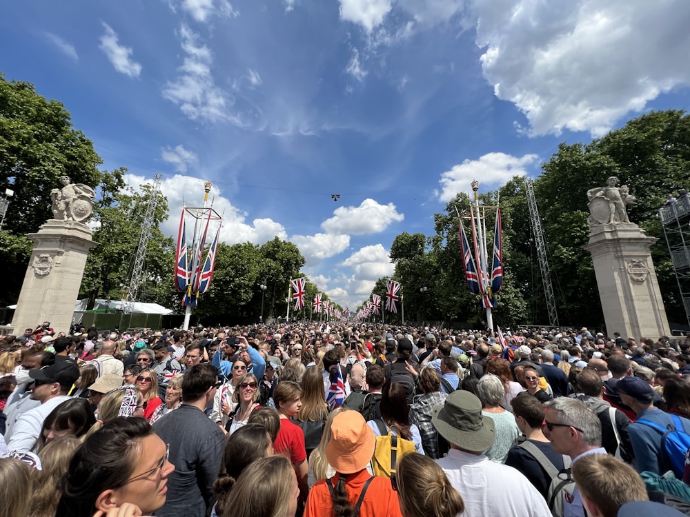 a large crowd of people standing in a park