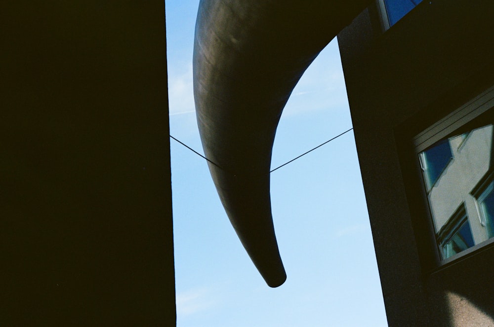 a large metal object hanging from the side of a building