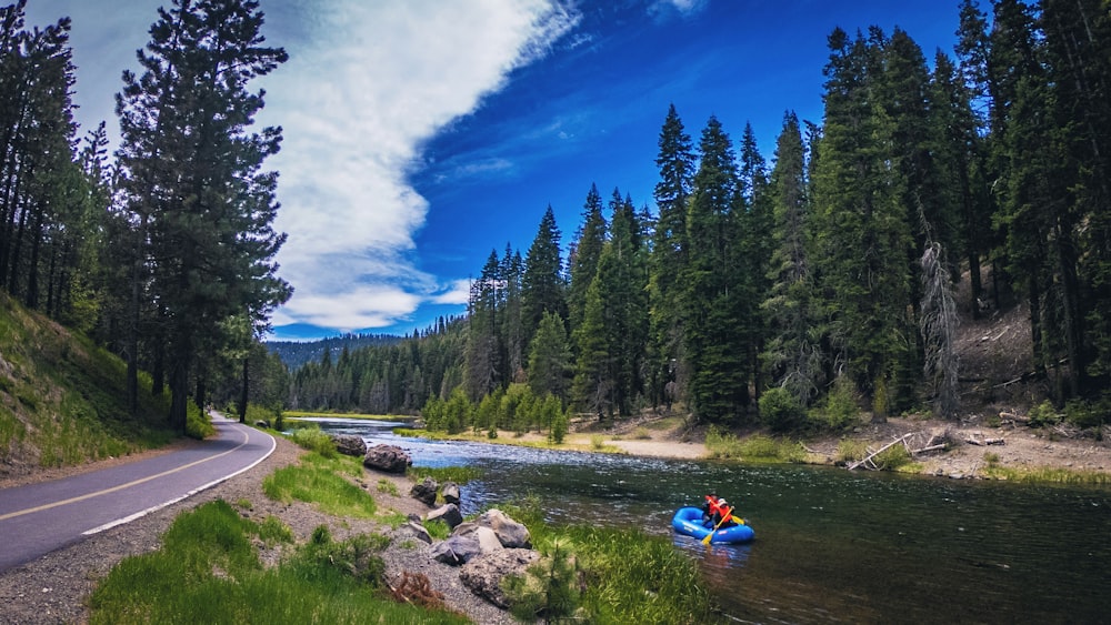 a person in a raft on the side of a river