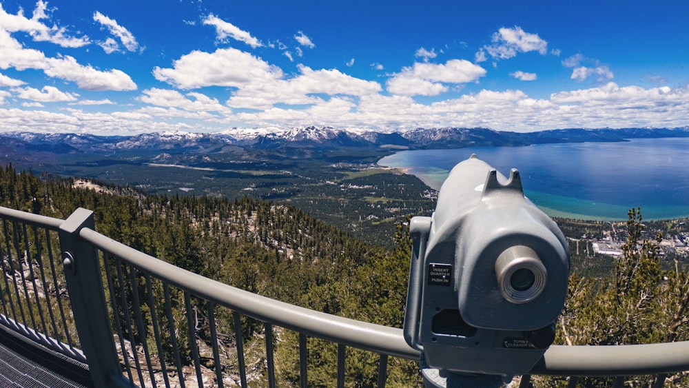 a pair of binoculars sitting on top of a metal railing