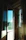 A man admiring a newly installed sliding glass door leading to a sunny terrace.