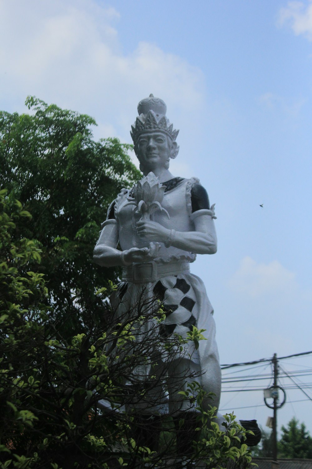 a statue of a woman holding a bird in her hands