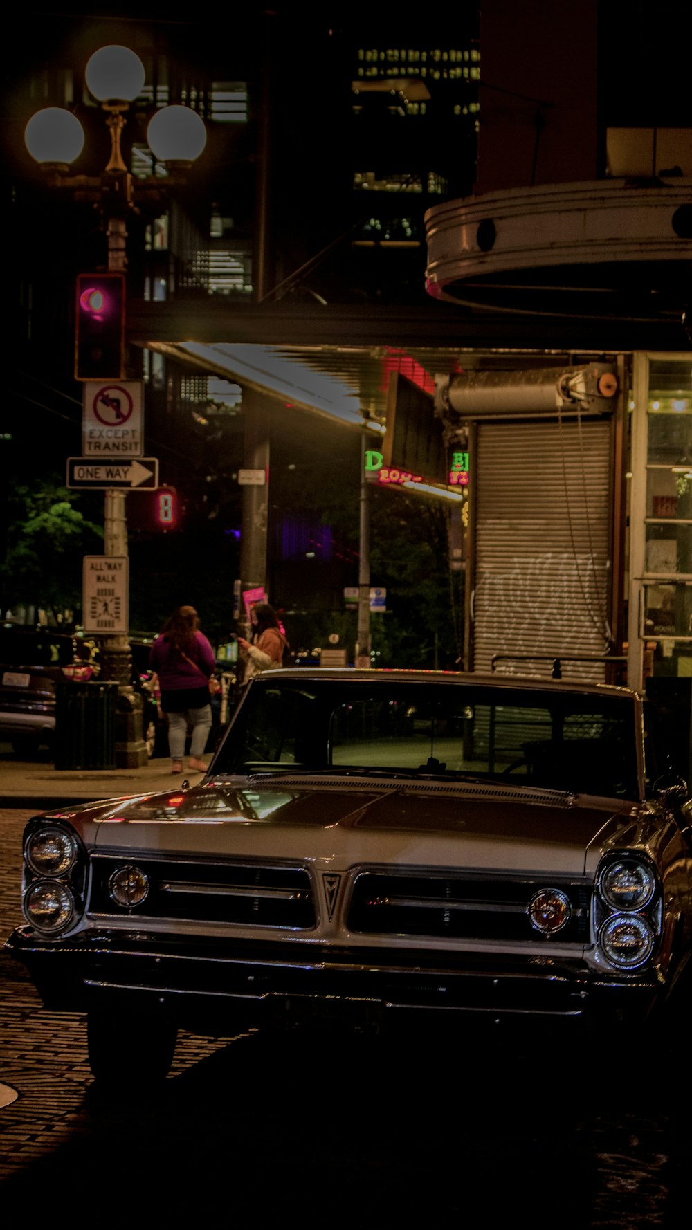 a car parked on the side of the road at night