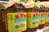 a row of bottles of honey sit on a shelf