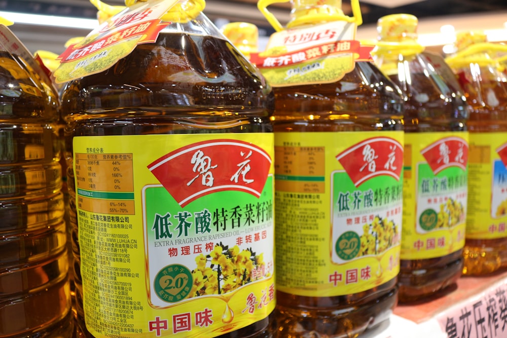 a row of bottles of honey sit on a shelf