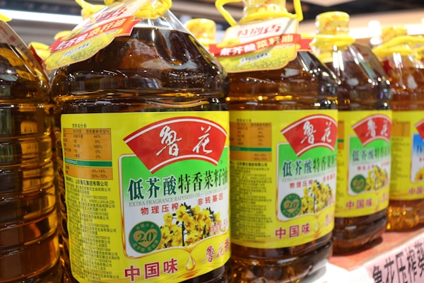A row of bottles of honey sit on a shelf