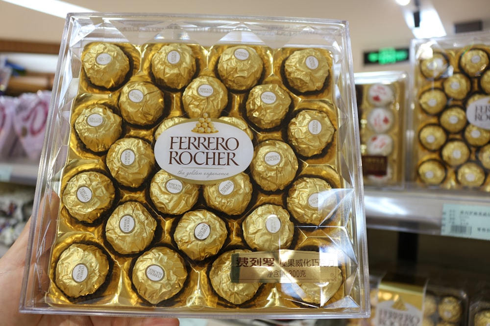 a person holding a box of chocolates in a store