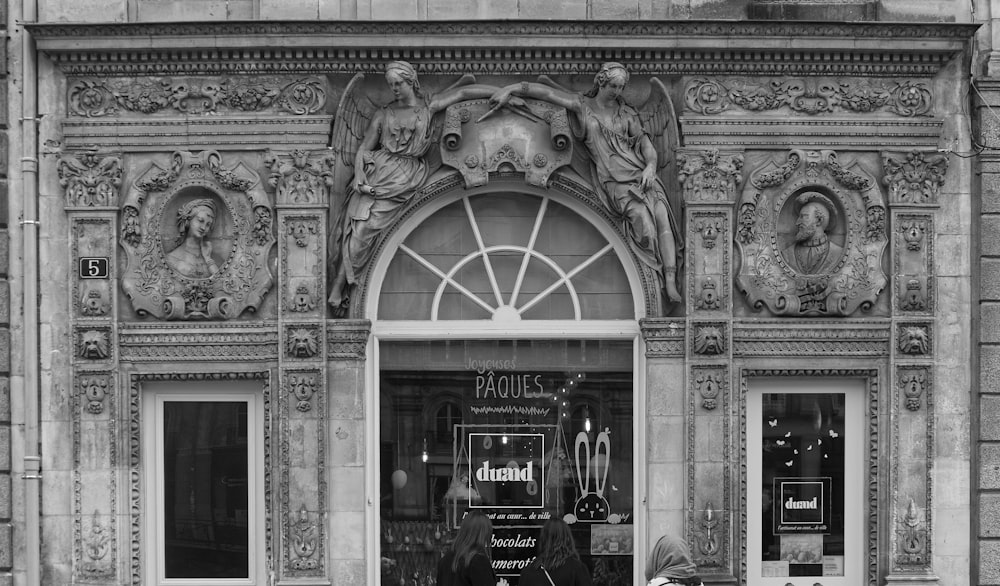 a woman sitting on a bench in front of a building