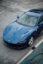 a blue sports car parked in a parking lot