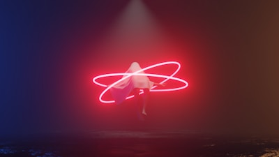 a person standing in the middle of a dark room with a neon light