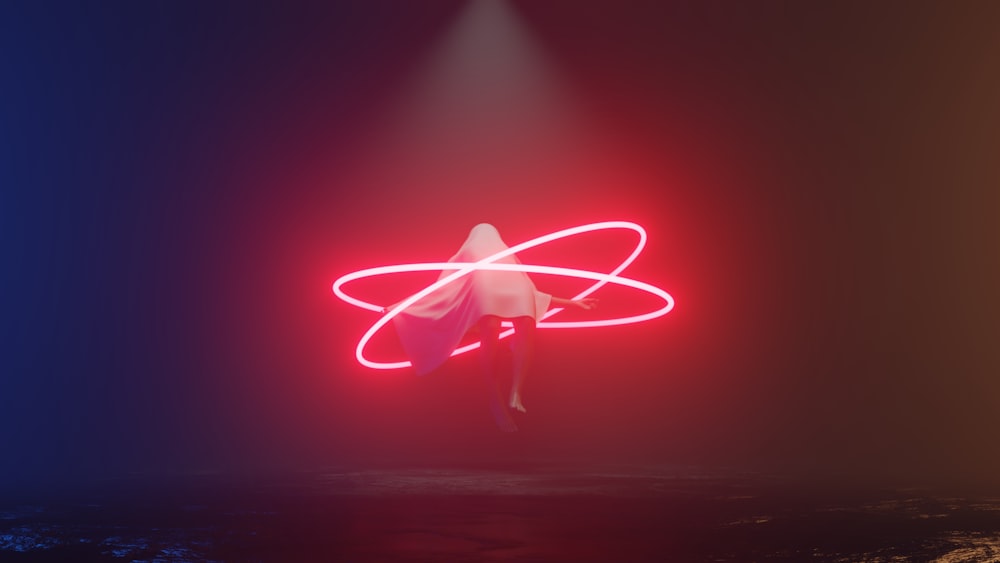 a person standing in the middle of a dark room with a neon light