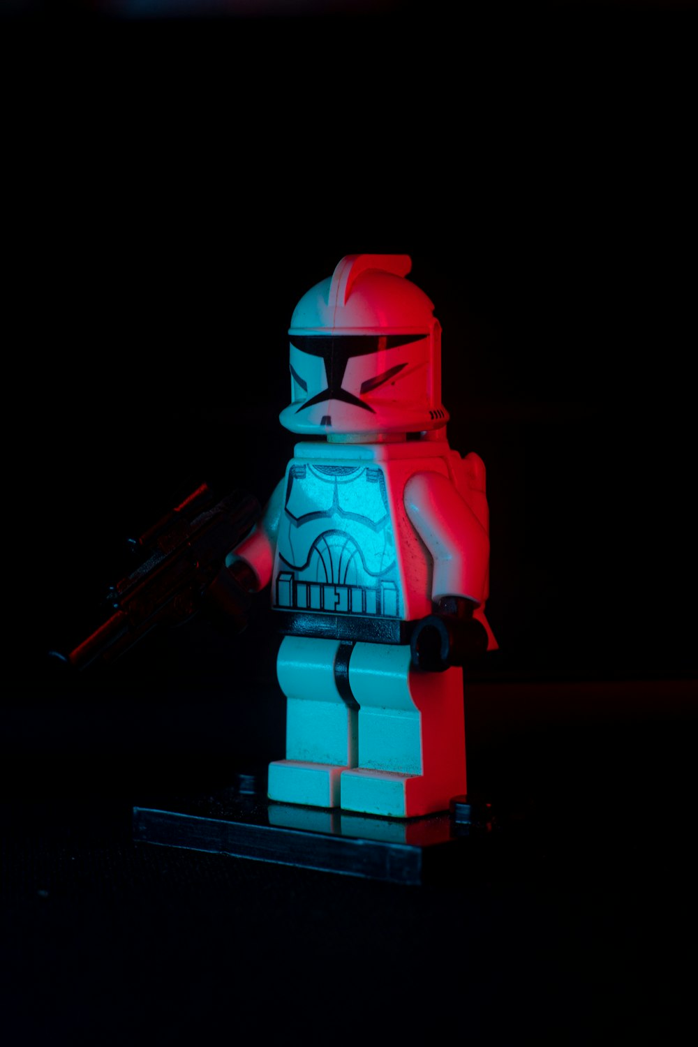 a lego star wars character holding a gun