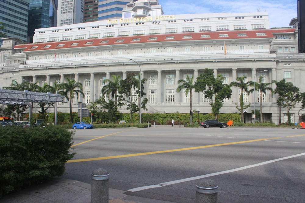 a large white building with palm trees in front of it