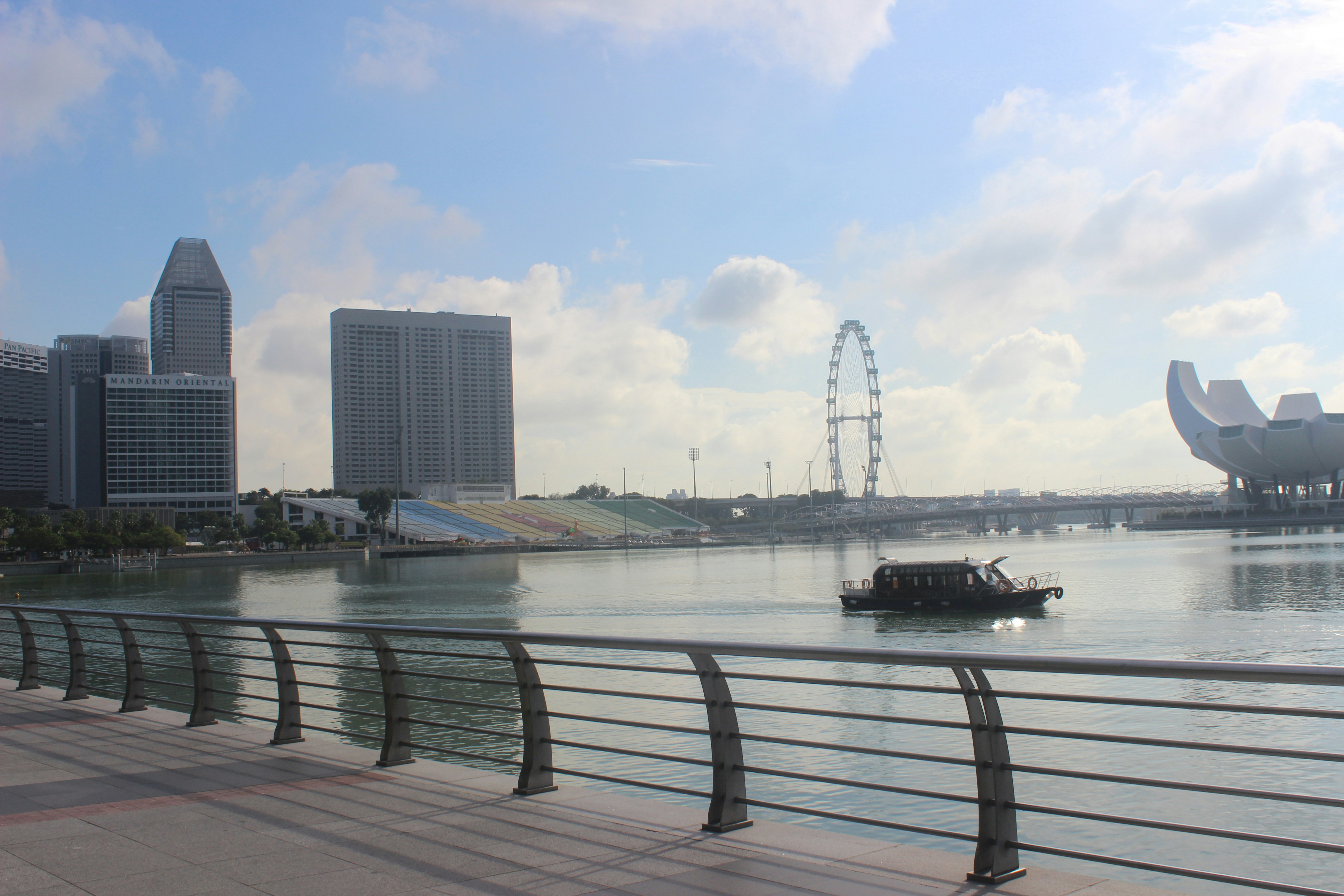 a boat traveling down a river next to tall buildings