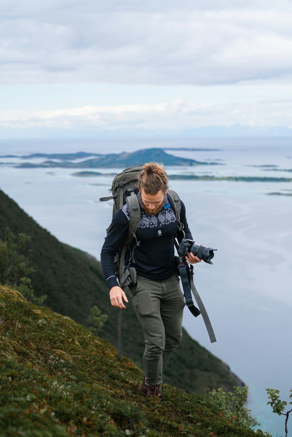 a person standing next to a body of water