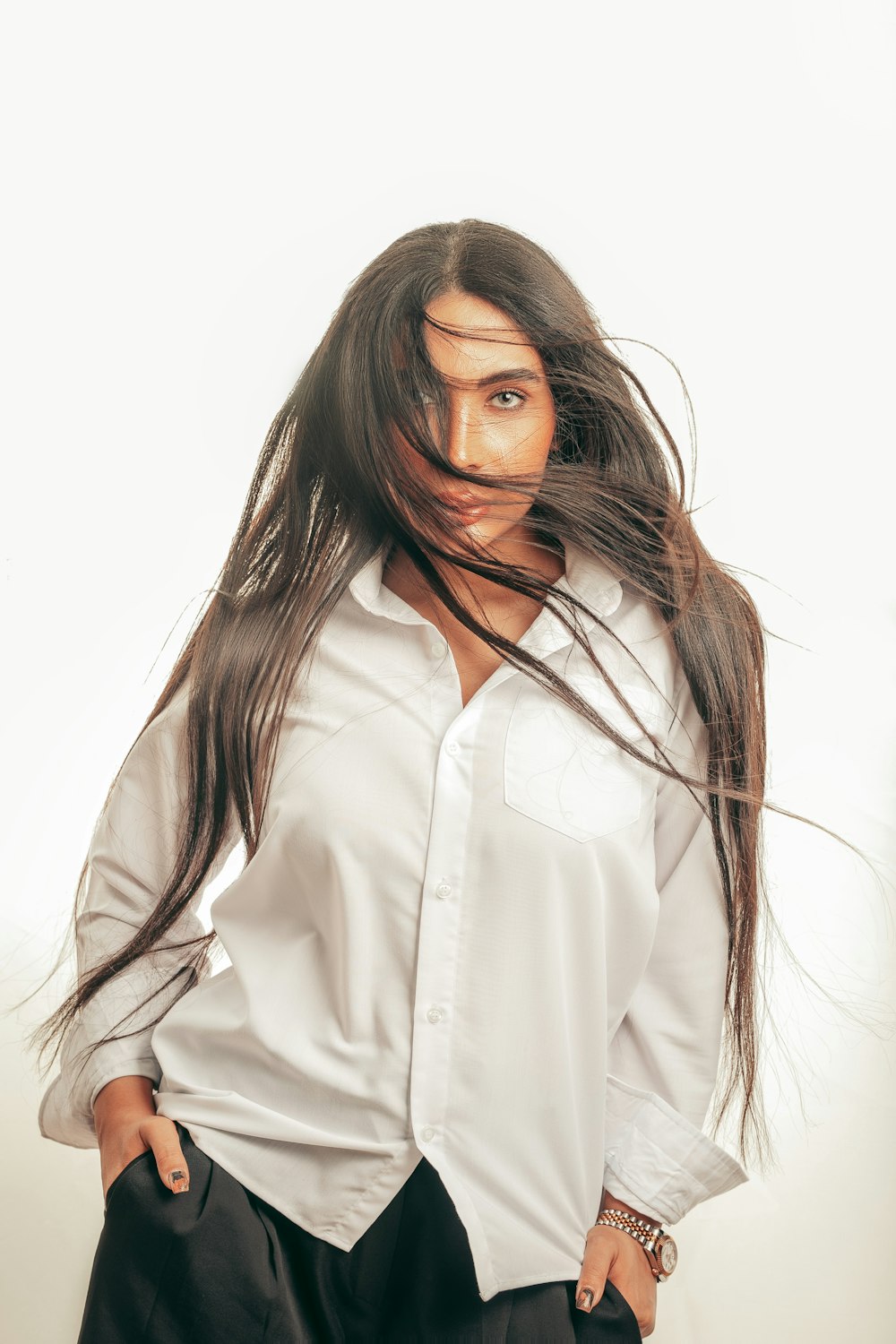 a woman in a white shirt and black pants