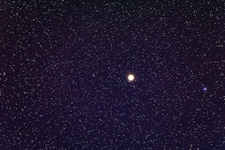 a night sky filled with stars and a bright moon