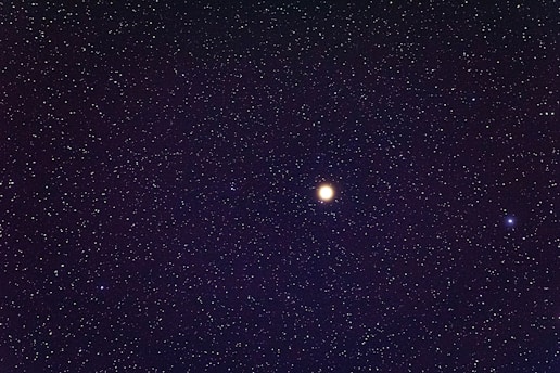 a night sky filled with stars and a bright moon