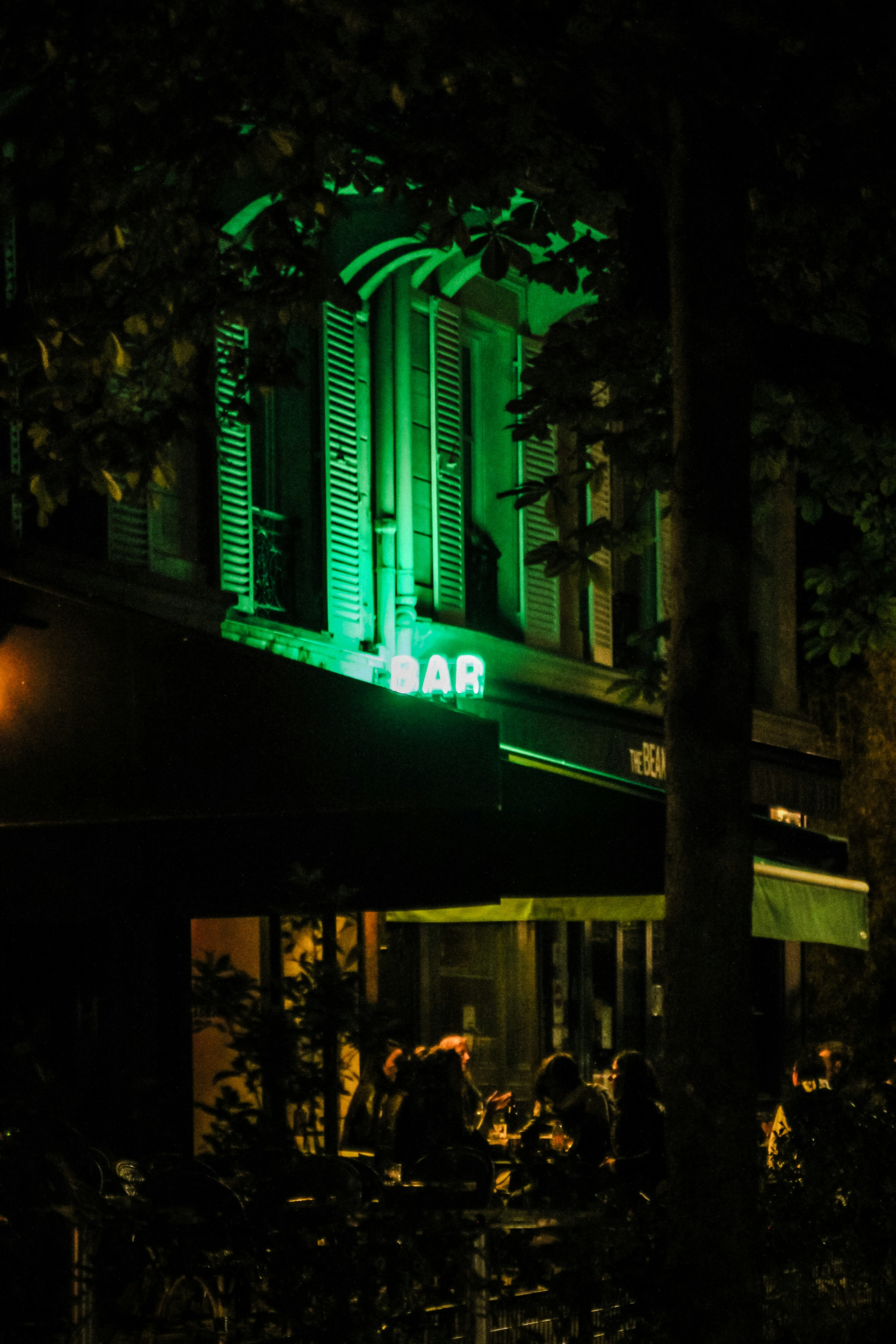 A building lit up with green lights at night photo – Free Night Image ...