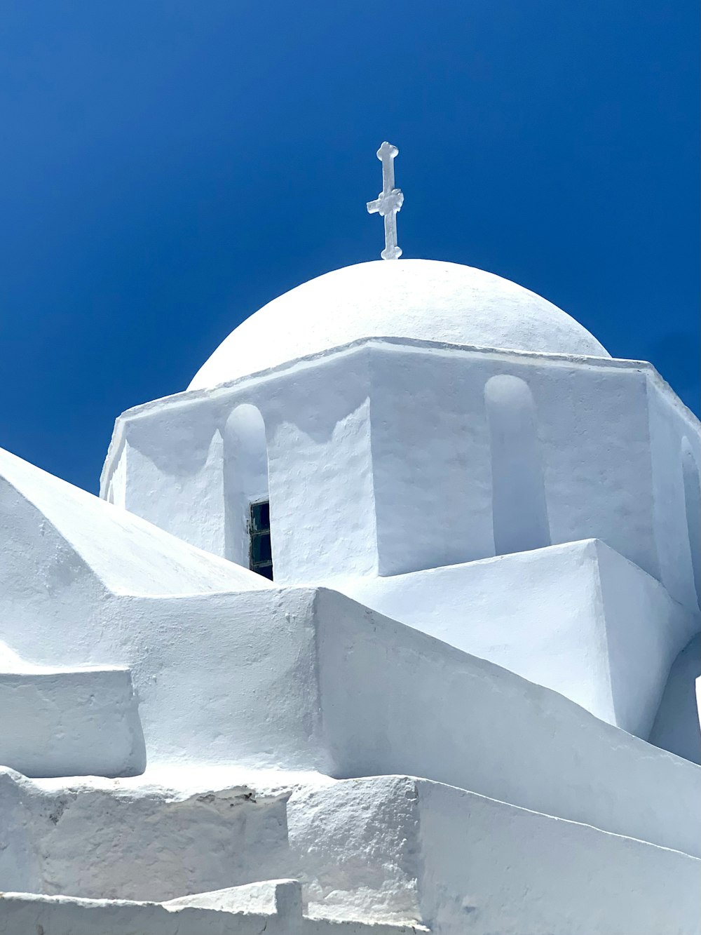 a white church with a cross on top of it