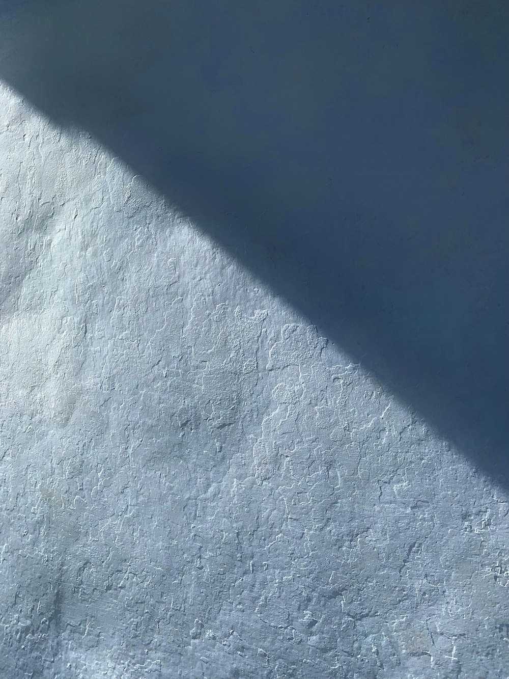 a white wall with a shadow of a person on it