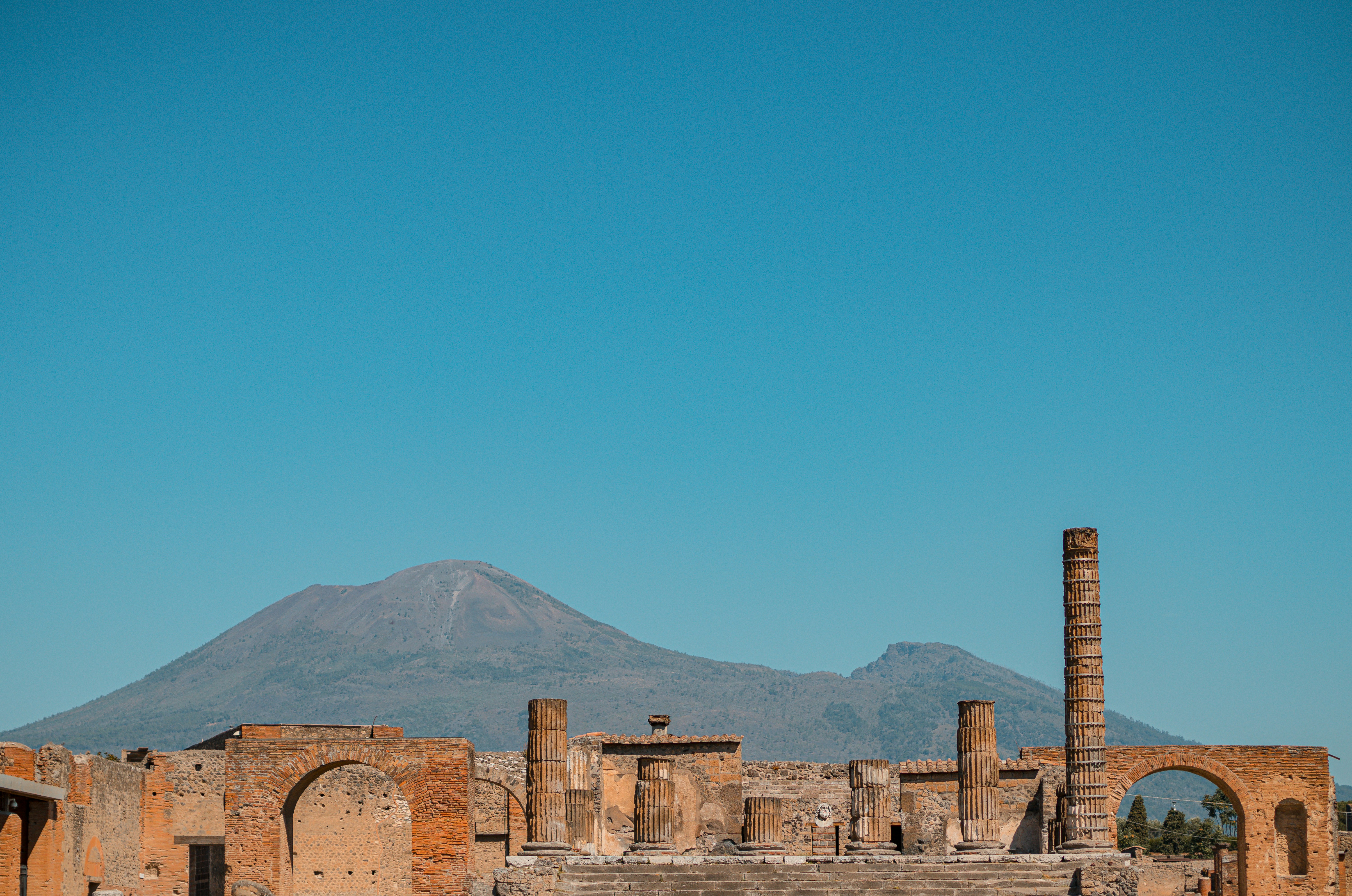 the ruins of a roman city with a mountain in the background